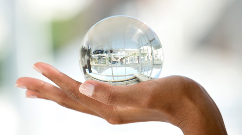 lady's hand holding a large crystal ball